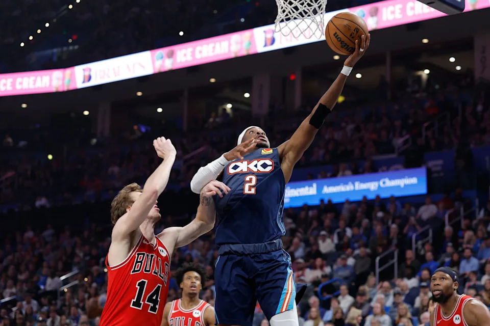 Mar 27, 2026; Oklahoma City, Oklahoma, USA; Oklahoma City Thunder guard Shai Gilgeous-Alexander (2) goes to the basket beside Chicago Bulls forward Matas Buzelis (14) during the first half at Paycom Center. Mandatory Credit: Alonzo Adams-Imagn Images
