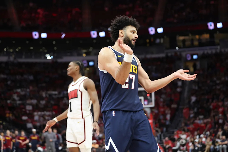 Mar 23, 2025; Houston, Texas, USA; Denver Nuggets guard Jamal Murray (27) and Houston Rockets forward Amen Thompson (1) react after a play during the fourth quarter at Toyota Center. Mandatory Credit: Troy Taormina-Imagn Images