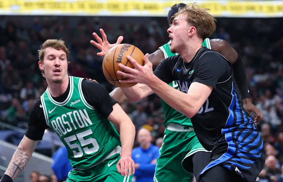 Feb 3, 2026; Dallas, Texas, USA; Dallas Mavericks forward Cooper Flagg (32) drives to the basket past Boston Celtics guard Baylor Scheierman (55) and center Neemias Queta (88) during the first quarter at American Airlines Center. Mandatory Credit: Kevin Jairaj-Imagn Images