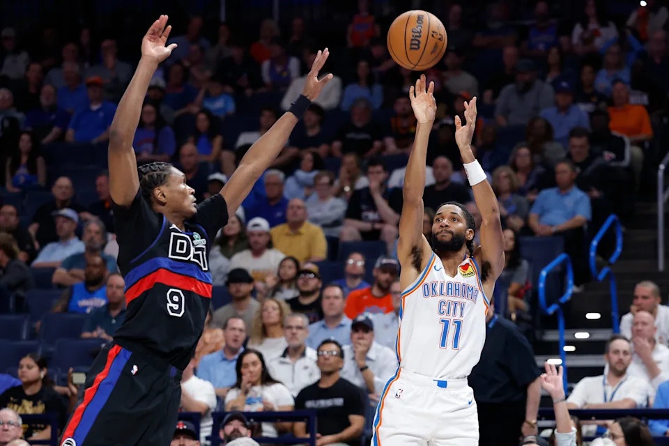 Mar 30, 2026; Oklahoma City, Oklahoma, USA; Oklahoma City Thunder guard Isaiah Joe (11) shoots a three point basket beside Detroit Pistons guard Ausar Thompson (9) during the second half at Paycom Center. Mandatory Credit: Alonzo Adams-Imagn Images