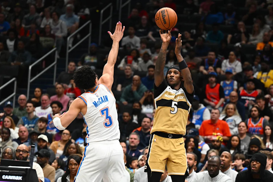 Mar 21, 2026; Washington, District of Columbia, USA; Washington Wizards forward Jamir Watkins (5) shoots over Oklahoma City Thunder guard Jared McCain (3) during the first half at Capital One Arena. Mandatory Credit: Brad Mills-Imagn Images
