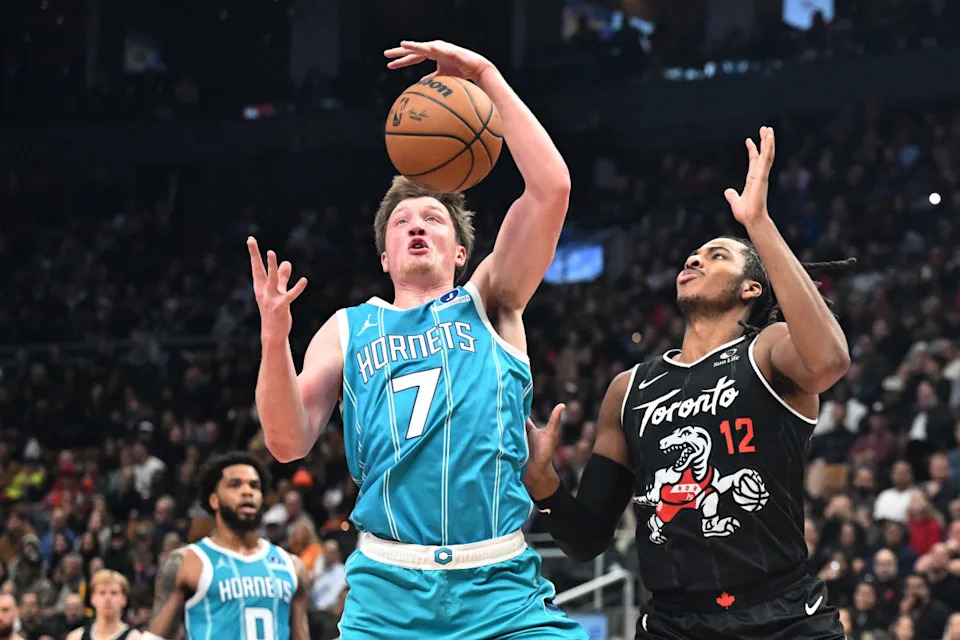 Charlotte Hornets forward Kon Kneuppel (7) blocks a pass intended for Toronto Raptors forward Collin Murray-Boyles (12) in the first half at Scotiabank Arena. Dan Hamilton-Imagn Images