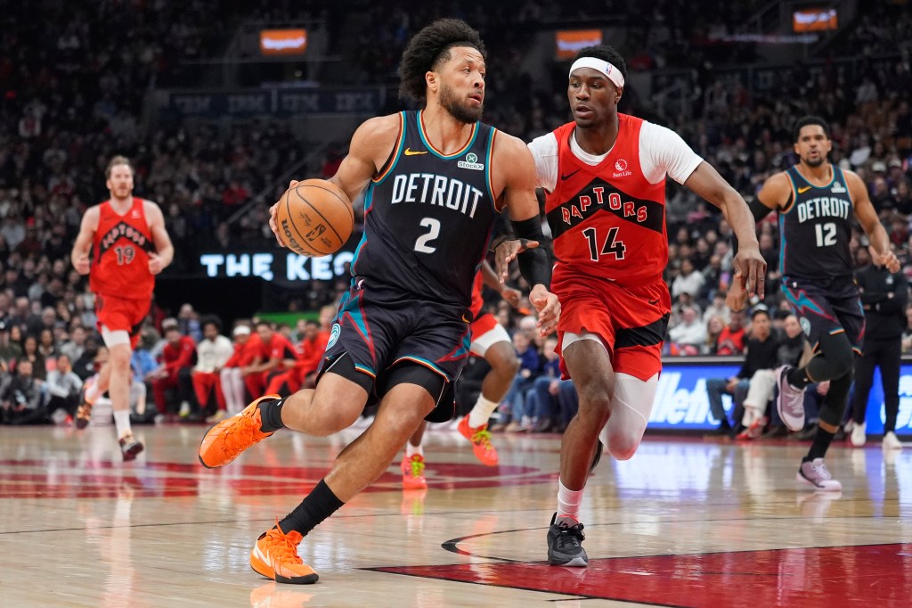Detroit Pistons guard Cade Cunningham (2) drives the ball against Toronto Raptors guard Ja'Kobe Walter (14) during a basketball game.