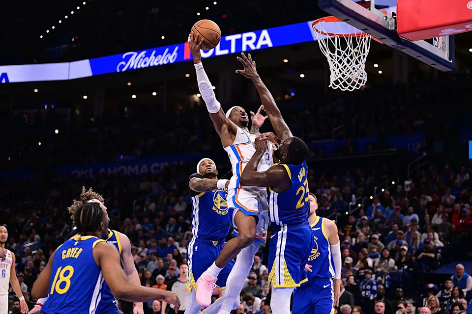 OKLAHOMA CITY, OKLAHOMA - MARCH 7: Shai Gilgeous-Alexander #2 of the Oklahoma City Thunder attempts a shot in front of Draymond Green #23 of the Golden State Warriors during the second half at Paycom Center on March 7, 2026 in Oklahoma City, Oklahoma. NOTE TO USER: User expressly acknowledges and agrees that, by downloading and or using this photograph, User is consenting to the terms and conditions of the Getty Images License Agreement. (Photo by Joshua Gateley/Getty Images)