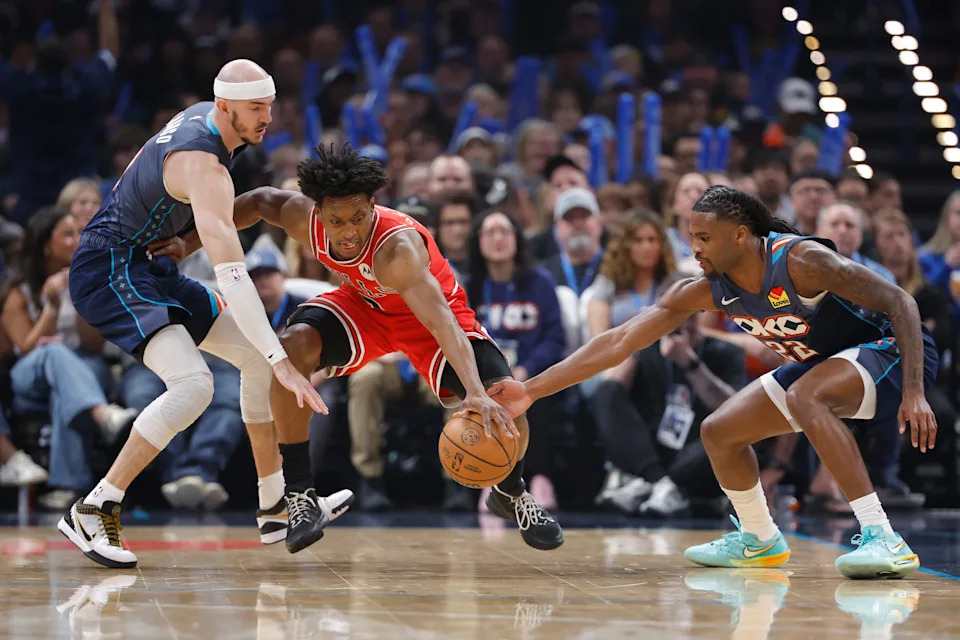 Mar 27, 2026; Oklahoma City, Oklahoma, USA; Chicago Bulls guard Collin Sexton (2) reaches for a loose ball between Oklahoma City Thunder guard Alex Caruso (9) and guard Cason Wallace (22) during the first quarter at Paycom Center. Mandatory Credit: Alonzo Adams-Imagn Images