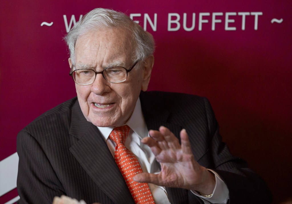 Warren Buffett speaking and gesturing.