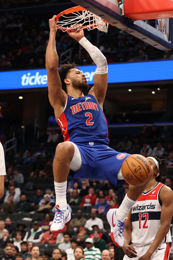 Detroit Pistons player Marvin Bagley III mid-dunk.