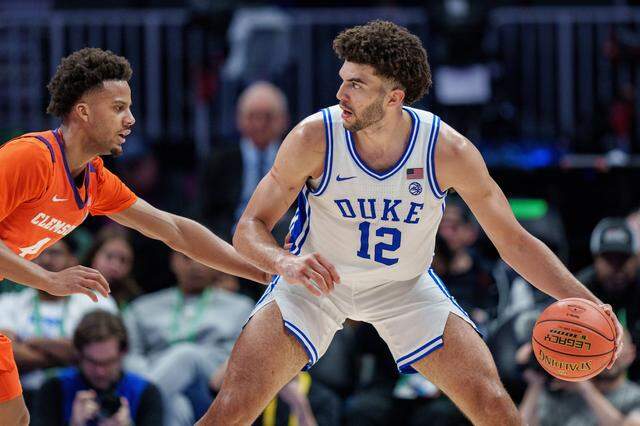 CHARLOTTE, NORTH CAROLINA - MARCH 13: Butta Johnson #4 of the Clemson Tigers guards Cameron Boozer #12 of the Duke Blue Devils in the second half during the semifinals of the men's ACC Tournament at Spectrum Center on March 13, 2026 in Charlotte, North Carolina. (Photo by Jacob Kupferman/Getty Images)