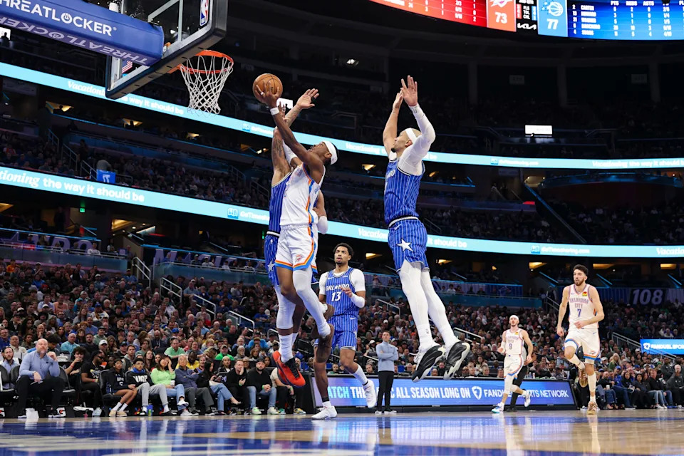 aMar 17, 2026; Orlando, Florida, USA; Oklahoma City Thunder guard Shai Gilgeous-Alexander (2) drives to the basket past Orlando Magic forward Paolo Banchero (5) in the third quarter at Kia Center. Mandatory Credit: Nathan Ray Seebeck-Imagn Images
