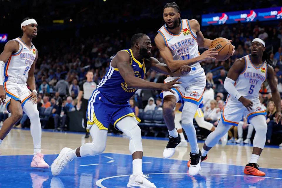 Mar 7, 2026; Oklahoma City, Oklahoma, USA; Golden State Warriors forward Draymond Green (23) pushes Oklahoma City Thunder guard Isaiah Joe (11) during a play during the second half at Paycom Center. Mandatory Credit: Alonzo Adams-Imagn Images