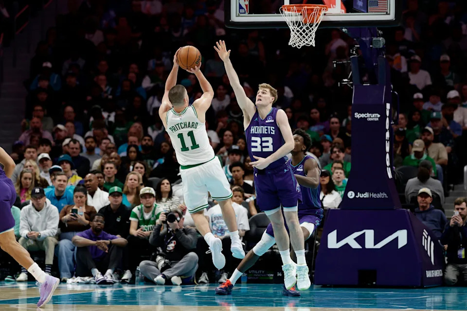 Mar 29, 2026; Charlotte, North Carolina, USA; Boston Celtics guard Payton Pritchard (11) shoots over Charlotte Hornets forward Liam McNeeley (33) during the second half at Spectrum Center. Mandatory Credit: Brian Westerholt-Imagn Images