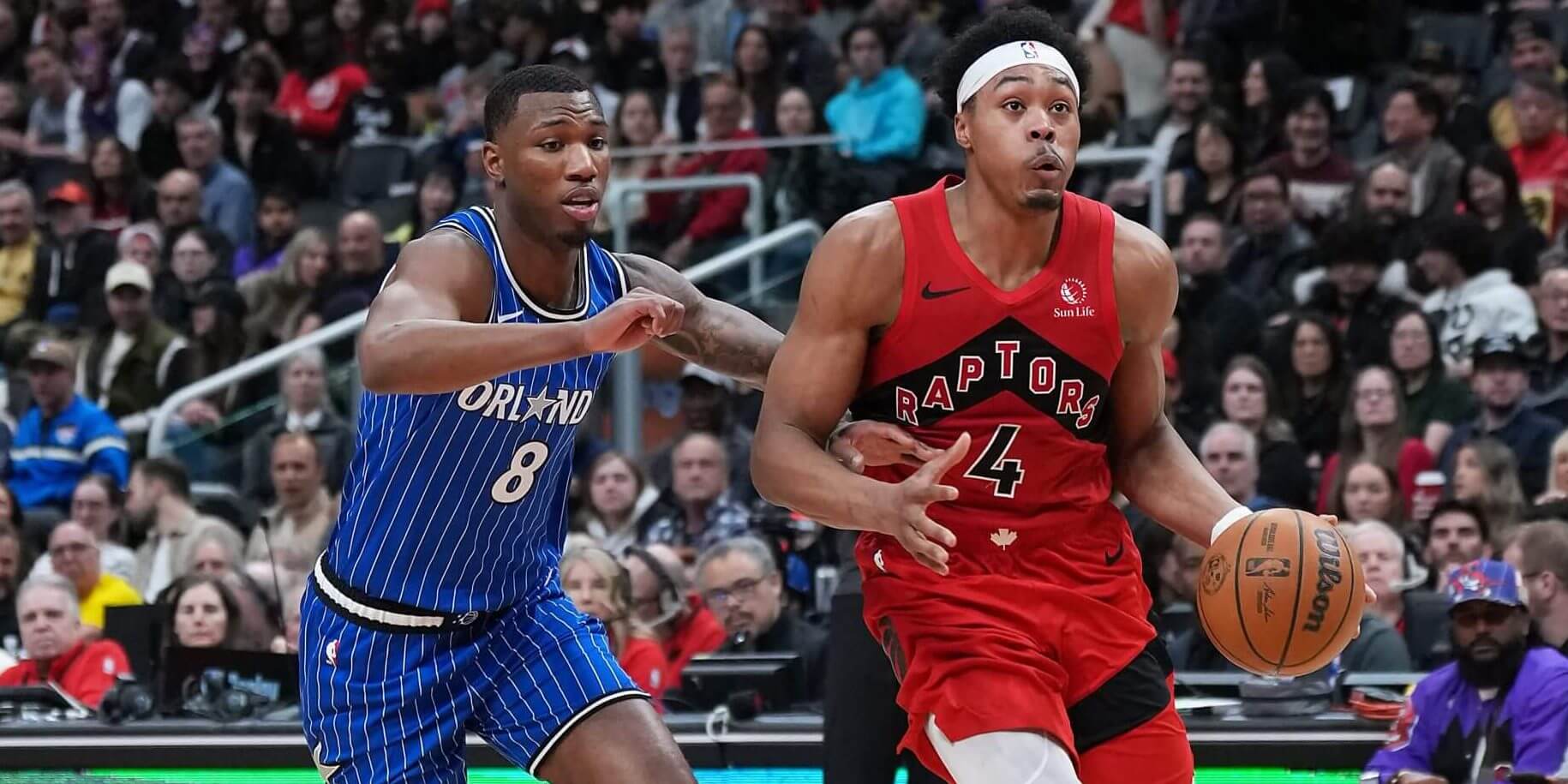 Raptors forward Scottie Barnes drives to the basket as Orlando Magic forward Jamal Cain guards