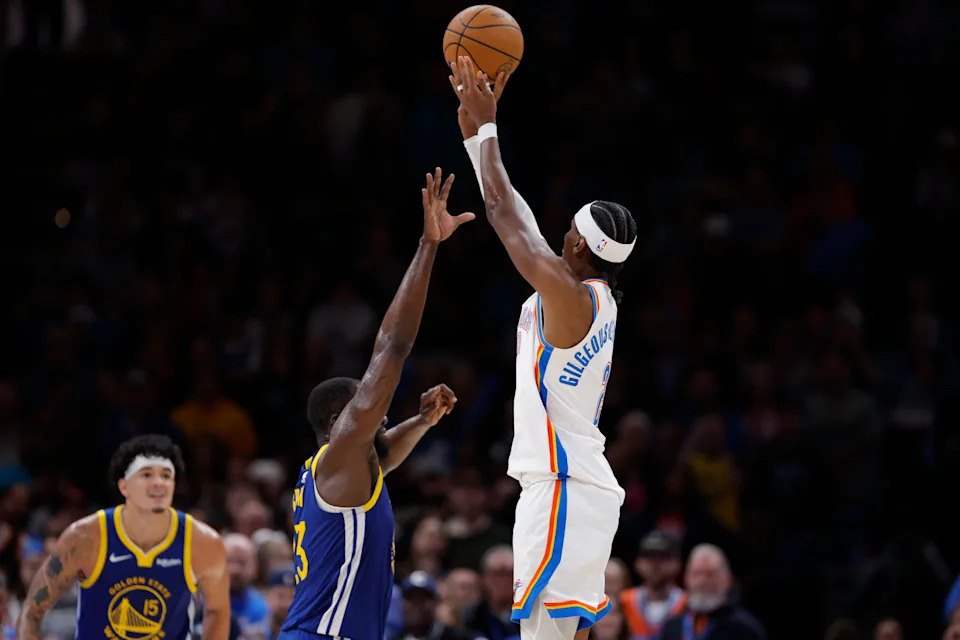 Mar 7, 2026; Oklahoma City, Oklahoma, USA; Oklahoma City Thunder guard Shai Gilgeous-Alexander (2) shoots over Golden State Warriors forward Draymond Green (23) during the second half at Paycom Center. Mandatory Credit: Alonzo Adams-Imagn Images