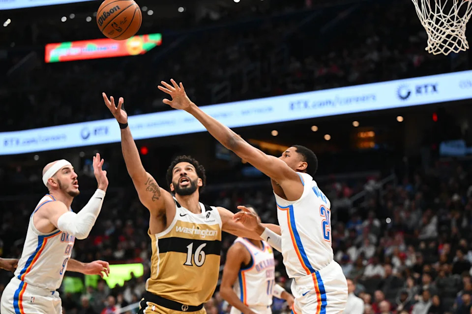 Mar 21, 2026; Washington, District of Columbia, USA; Washington Wizards forward Anthony Gill (16) reaches for a rebound against Oklahoma City Thunder guard Aaron Wiggins (21) during the first half at Capital One Arena. Mandatory Credit: Brad Mills-Imagn Images