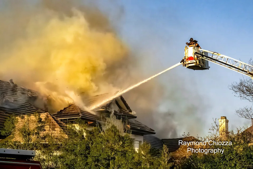 Crews with the Shelby County Fire Department and Memphis Fire Department battle a house fire near TPC Southwind on Thursday, March 26, 2026. The home was once owned by Memphis basketball star Lorenzen Wright.