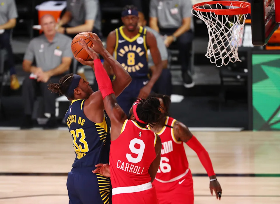 Aug 12, 2020; Lake Buena Vista, Florida, USA; Indiana Pacers center Myles Turner (33) shoots against Houston Rockets forward DeMarre Carroll (9) in the fourth quarter of a NBA basketball game at AdventHealth Arena. Mandatory Credit: Kim Klement-USA TODAY Sports