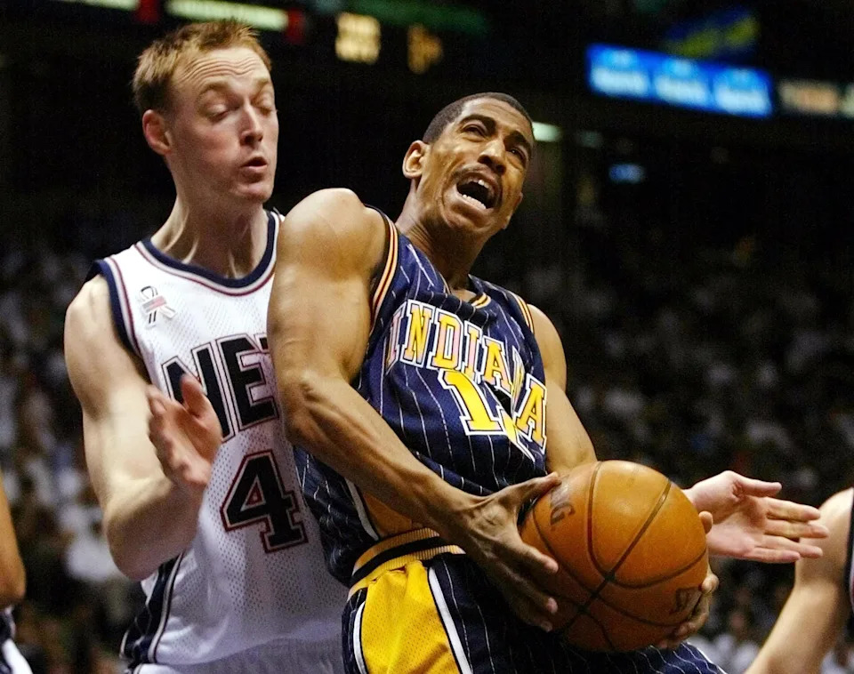 EAST RUTHERFORD, UNITED STATES: Indiana Pacers guard Kevin Ollie (R) gets fouled from behind by New Jersey Nets forward Keith Van Horn (L) in the third quarter 20 April, 2002 during the first round of the NBA Playoffs at Continental Airlines Arena in East Rutherford, NJ. The Pacers beat the Nets 89-83 to take a 1-0 lead in the best-of-five series.        AFP PHOTO/Matt CAMPBELL (Photo credit should read MATT CAMPBELL/AFP via Getty Images)