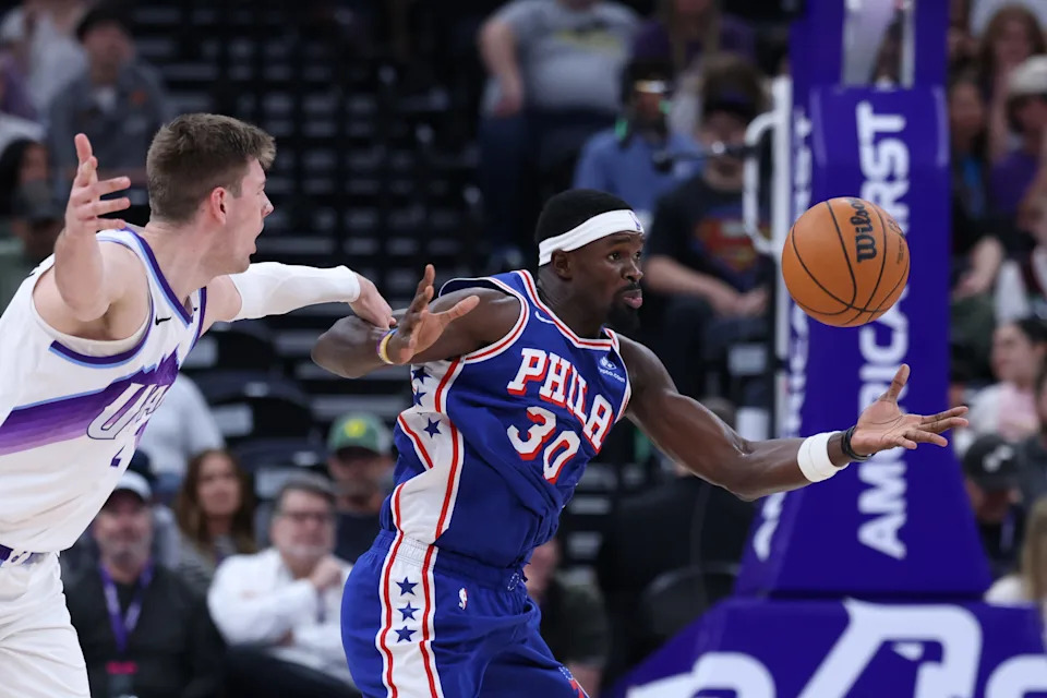 Mar 21, 2026; Salt Lake City, Utah, USA; Utah Jazz forward Kyle Filipowski (22) and Philadelphia 76ers center Adem Bona (30) play for a loose ball during the first half at Delta Center. Mandatory Credit: Rob Gray-Imagn Images