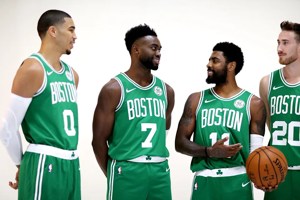 CANTON, MA - SEPTEMBER 24: From left, Jayson Tatum #0, Jaylen Brown #7, Kyrie Irving #11 and Gordon Hayward #20 talk together during a photoshoot on Boston Celtics Media Day on September 24, 2018 in Canton, Massachusetts. NOTE TO USER: User expressly acknowledges and agrees that, by downloading and/or using this photograph, user is consenting to the terms and conditions of the Getty Images License Agreement. (Photo by Maddie Meyer/Getty Images)