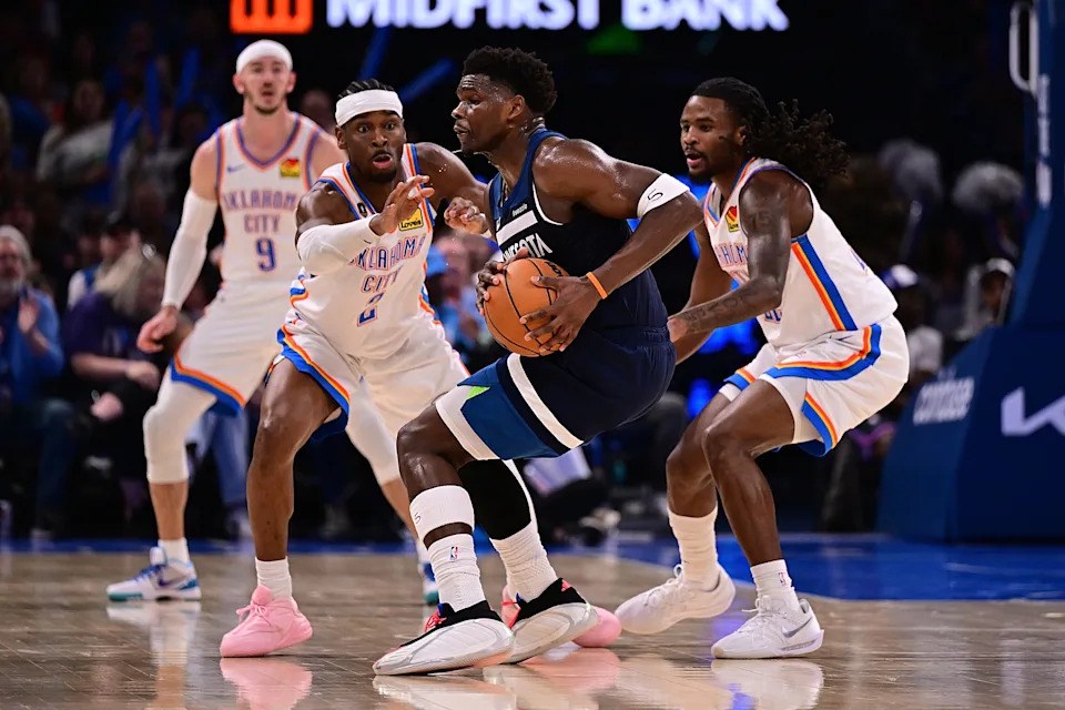 OKLAHOMA CITY, OKLAHOMA - MARCH 15: Anthony Edwards #5 of the Minnesota Timberwolves handles the ball in between Shai Gilgeous-Alexander #2 and Cason Wallace #22 of the Oklahoma City Thunder during the second half at Paycom Center on March 15, 2026 in Oklahoma City, Oklahoma. NOTE TO USER: User expressly acknowledges and agrees that, by downloading and or using this photograph, User is consenting to the terms and conditions of the Getty Images License Agreement. (Photo by Joshua Gateley/Getty Images)