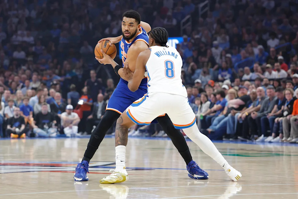 Mar 29, 2026; Oklahoma City, Oklahoma, USA; New York Knicks center Karl-Anthony Towns (32) is defended by Oklahoma City Thunder guard Jalen Williams (8) on a play during the first half at Paycom Center. Mandatory Credit: Alonzo Adams-Imagn Images