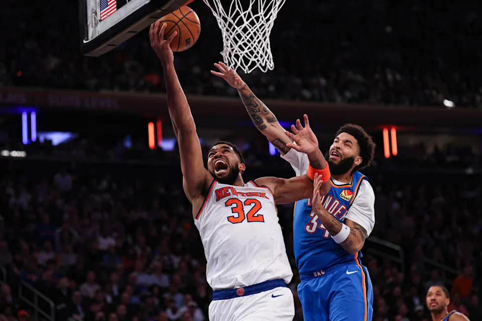 Mar 4, 2026; New York, New York, USA; New York Knicks center Karl-Anthony Towns (32) goes to the basket against Oklahoma City Thunder guard Kenrich Williams (34) during the second half at Madison Square Garden. Mandatory Credit: Vincent Carchietta-Imagn Images