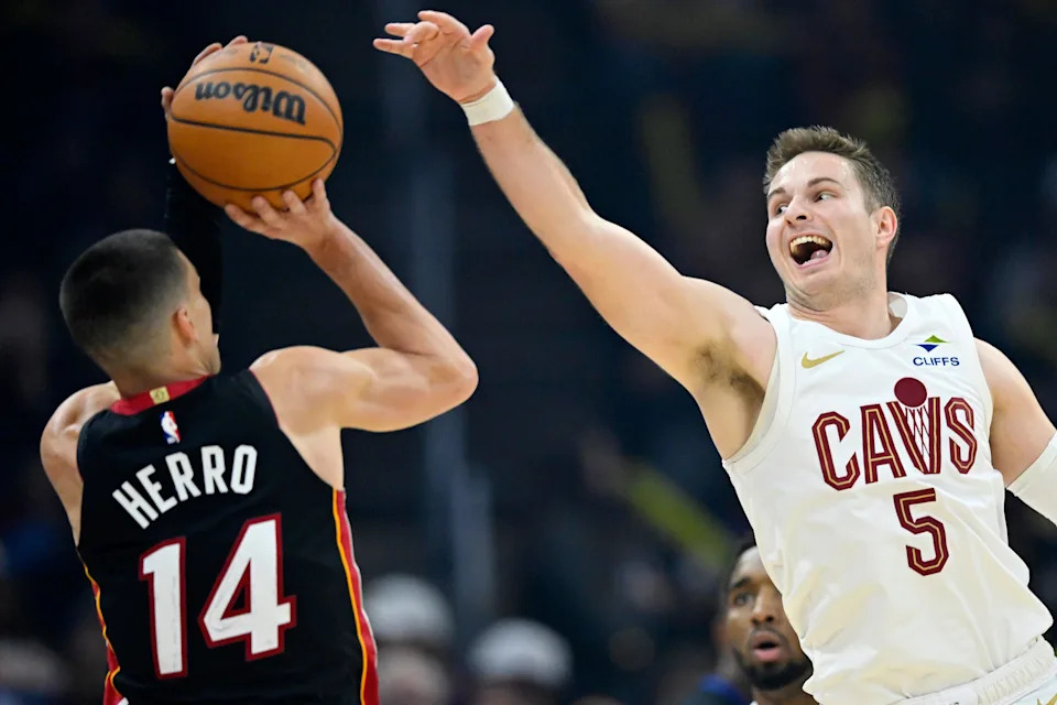 Mar 25, 2026; Cleveland, Ohio, USA; Miami Heat guard Tyler Herro (14) shoots as Cleveland Cavaliers guard Sam Merrill (5) defends in the third quarter at Rocket Arena. Mandatory Credit: David Richard-Imagn Images