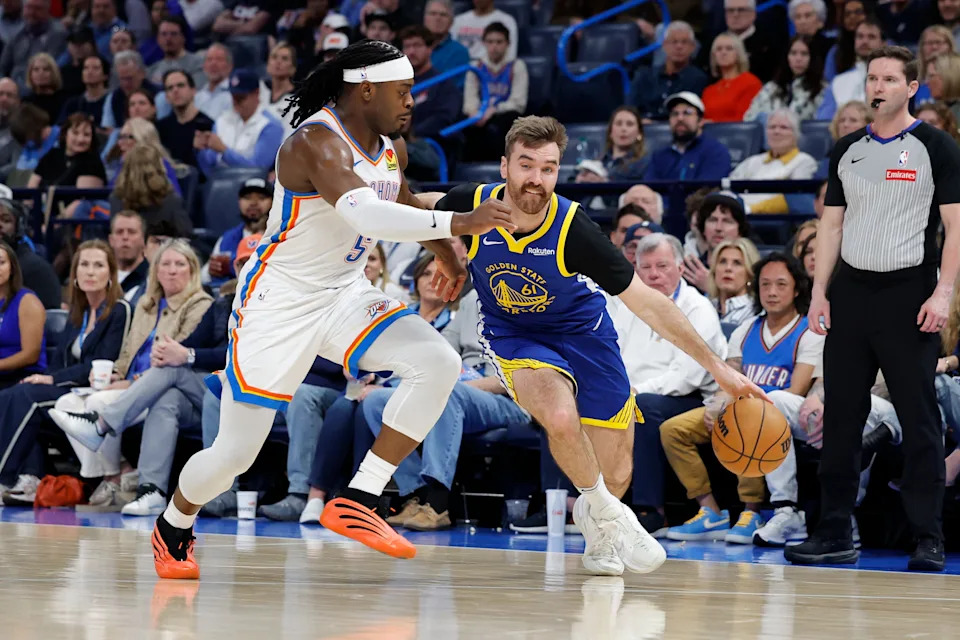 Mar 7, 2026; Oklahoma City, Oklahoma, USA; Golden State Warriors guard Pat Spencer (61) drives to the basket around Oklahoma City Thunder guard Luguentz Dort (5) during the second half at Paycom Center. Mandatory Credit: Alonzo Adams-Imagn Images