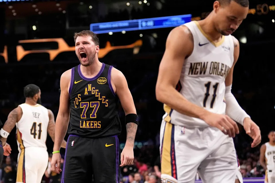 Los Angeles Lakers guard Luka Doncic, center, yells after scoring as New Orleans Pelicans guard Bryce McGowens, right, walks away during the second half of an NBA basketball game Tuesday, March 3, 2026, in Los Angeles. (AP Photo/Mark J. Terrill) AP
