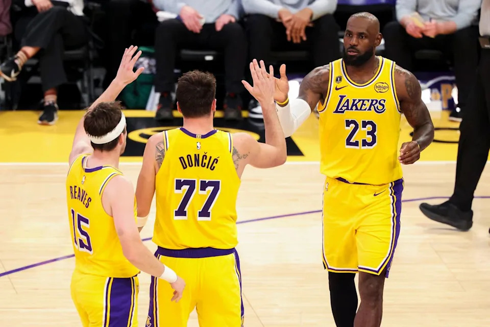 LeBron James #23 high fives Luka Dončić #77 and Austin Reaves #15 of the Los Angeles Lakers during an NBA basketball game against the Chicago Bulls, Thursday March 12, 2026 in Los Angeles, Calif.