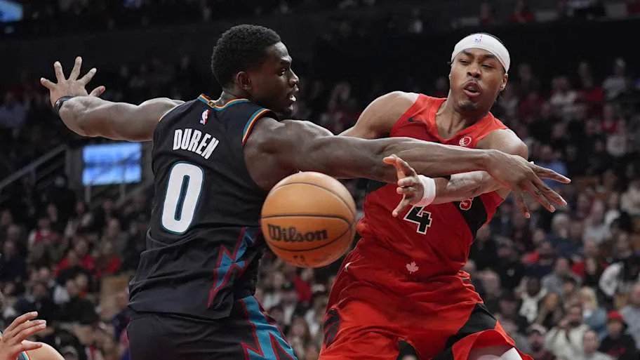 Toronto Raptors guard Scottie Barnes passes the ball past Detroit Pistons center Jalen Dure