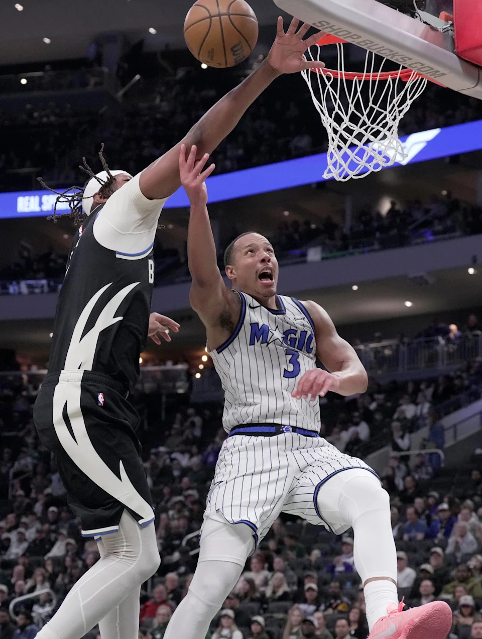 Milwaukee Bucks center Myles Turner (3) fouls Orlando Magic guard Desmond Bane (3) during the first half on Sunday, March 8 at Fiserv Forum in Milwaukee.