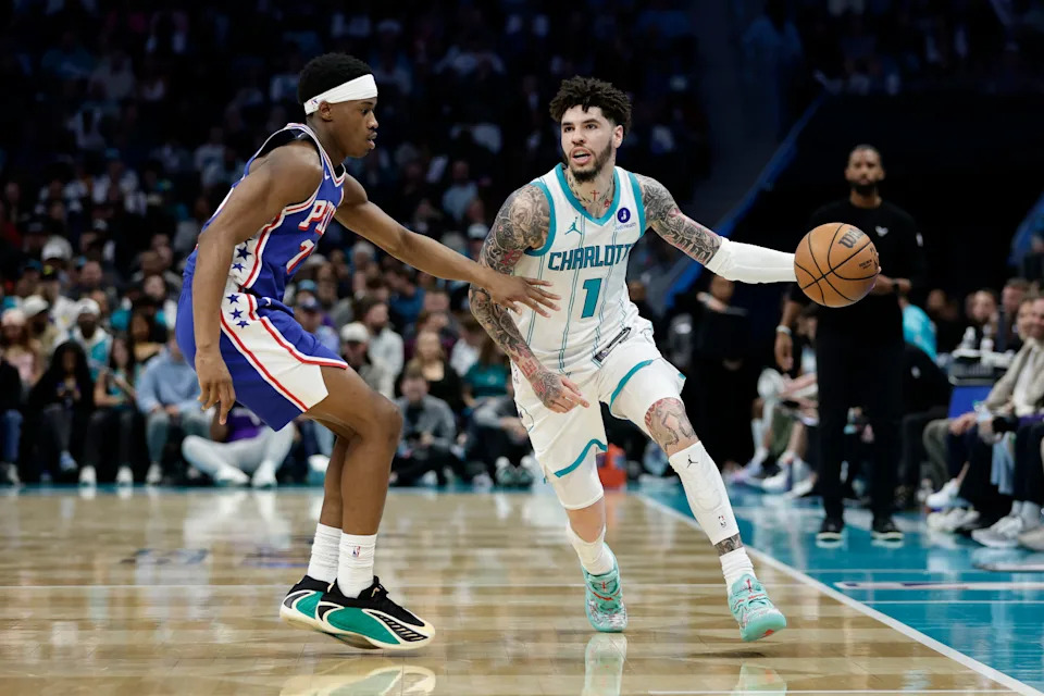 Mar 28, 2026; Charlotte, North Carolina, USA; Charlotte Hornets guard LaMelo Ball (1) tries to drive past Philadelphia 76ers guard V.J. Edgecombe (77) during the fourth quarter at Spectrum Center. Mandatory Credit: Brian Westerholt-Imagn Images