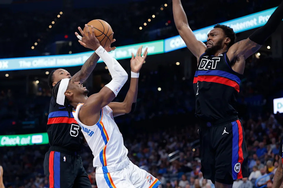 Mar 30, 2026; Oklahoma City, Oklahoma, USA; Oklahoma City Thunder guard Shai Gilgeous-Alexander (2) shoots between Detroit Pistons forward Paul Reed (7) and forward Ronald Holland II (5) during the second half at Paycom Center. Mandatory Credit: Alonzo Adams-Imagn Images