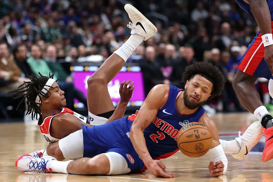 Tre Johnson of the Washington Wizards and Cade Cunningham of the Detroit Pistons collide during the first quarter at Capital One Arena on March 17, 2026 in Washington, DC.