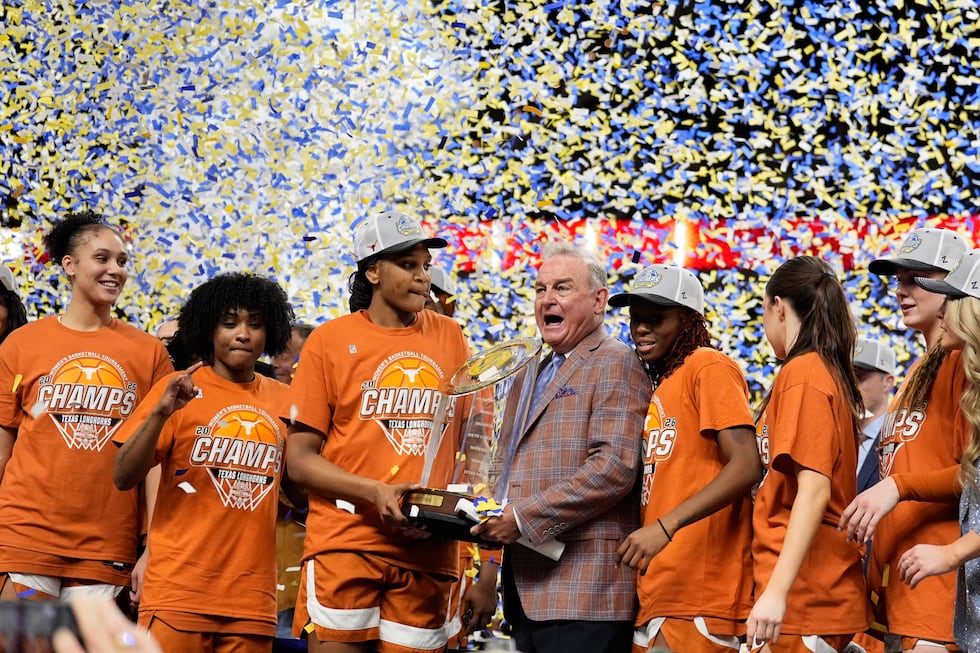Texas celebrates after their win against South Carolina in an NCAA college basketball game in...
