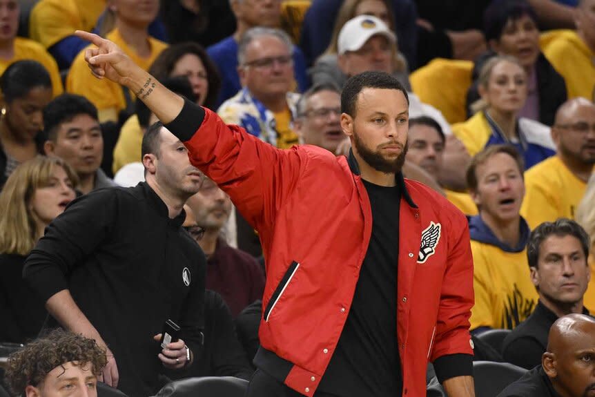 Stephen Curry stands and points at Game Four of the 2025 NBA Playoffs.