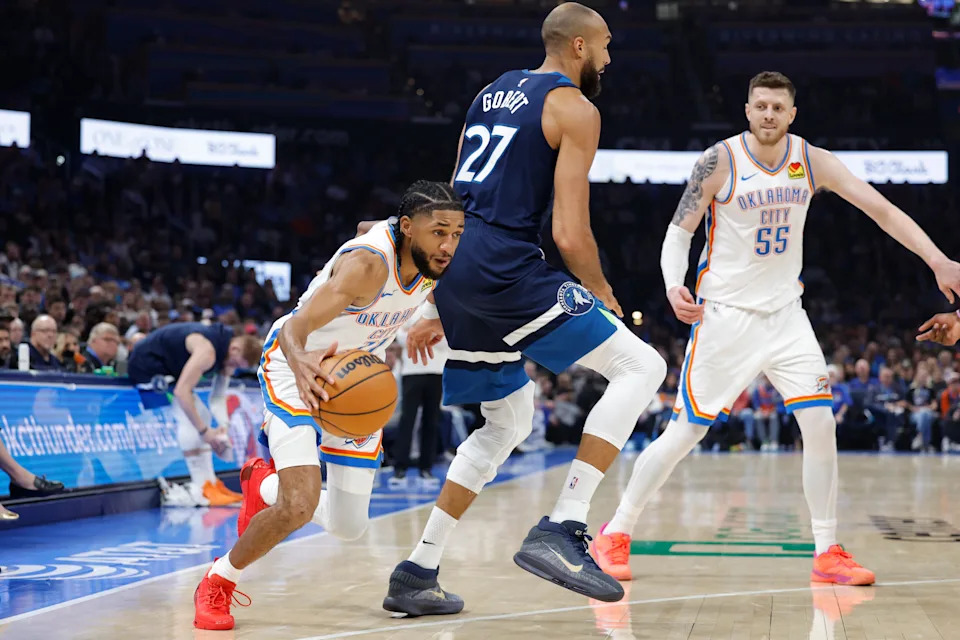 Mar 15, 2026; Oklahoma City, Oklahoma, USA; Oklahoma City Thunder guard Isaiah Joe (11) moves the ball around Minnesota Timberwolves center Rudy Gobert (27) during the first half at Paycom Center. Mandatory Credit: Alonzo Adams-Imagn Images