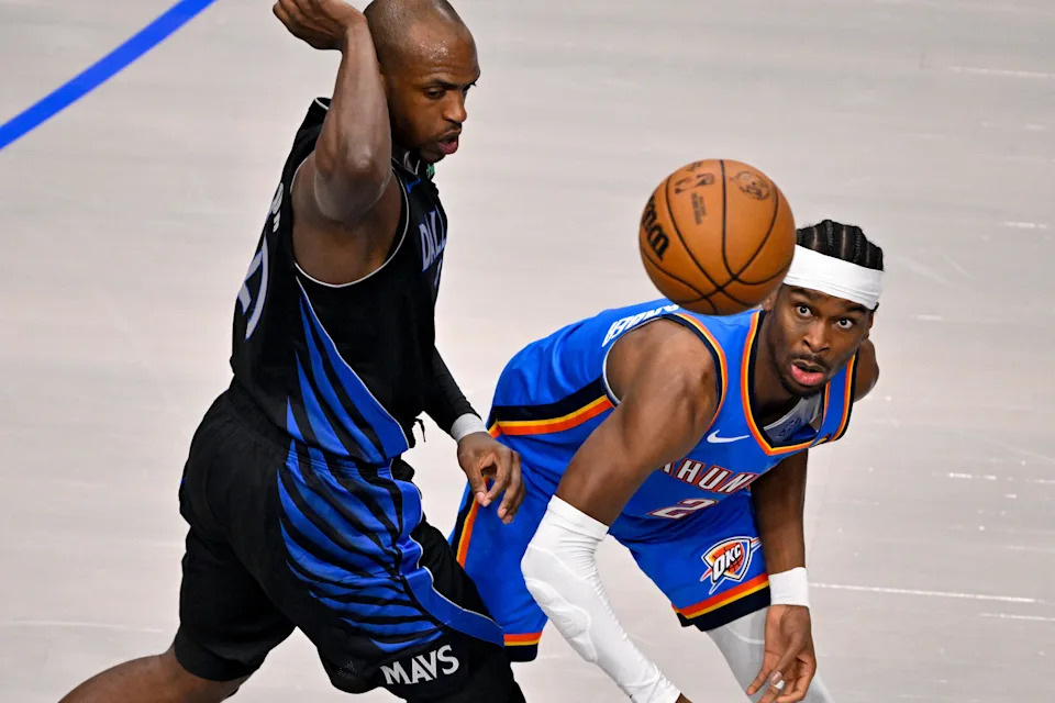 Mar 1, 2026; Dallas, Texas, USA; Dallas Mavericks forward Khris Middleton (20) and Oklahoma City Thunder guard Shai Gilgeous-Alexander (2) battle for the loose ball during the first quarter at the American Airlines Center. Mandatory Credit: Jerome Miron-Imagn Images