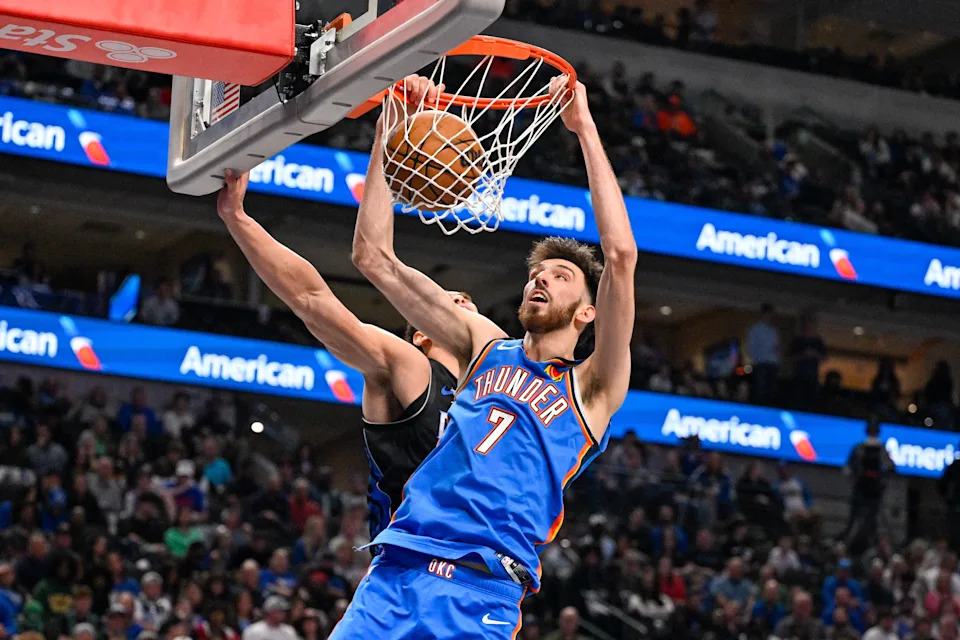 Mar 1, 2026; Dallas, Texas, USA; Oklahoma City Thunder center Chet Holmgren (7) dunks the ball past Dallas Mavericks forward Dwight Powell (7) during the second half at the American Airlines Center. Mandatory Credit: Jerome Miron-Imagn Images