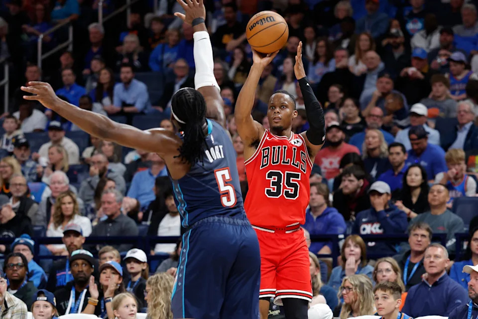 Mar 27, 2026; Oklahoma City, Oklahoma, USA; Chicago Bulls forward Isaac Okoro (35) shoots as Oklahoma City Thunder guard Luguentz Dort (5) defends during the second half at Paycom Center. Mandatory Credit: Alonzo Adams-Imagn Images