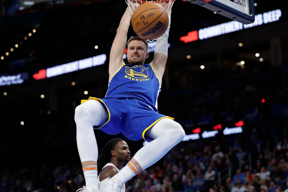 Mar 7, 2026; Oklahoma City, Oklahoma, USA; Golden State Warriors forward/center Kristaps Porziņģis (7) dunks against the Oklahoma City Thunder during the second half at Paycom Center. Mandatory Credit: Alonzo Adams-Imagn Images