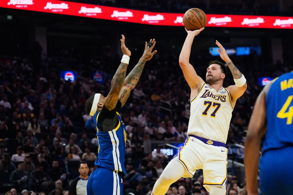 Los Angeles Lakers guard Luka Doncic (77) shoots over Golden State Warriors guard Gary Payton II (0) during the first half of an NBA basketball game, Saturday, Feb. 28, 2026, in San Francisco. (AP Photo/Godofredo A. Vásquez) AP