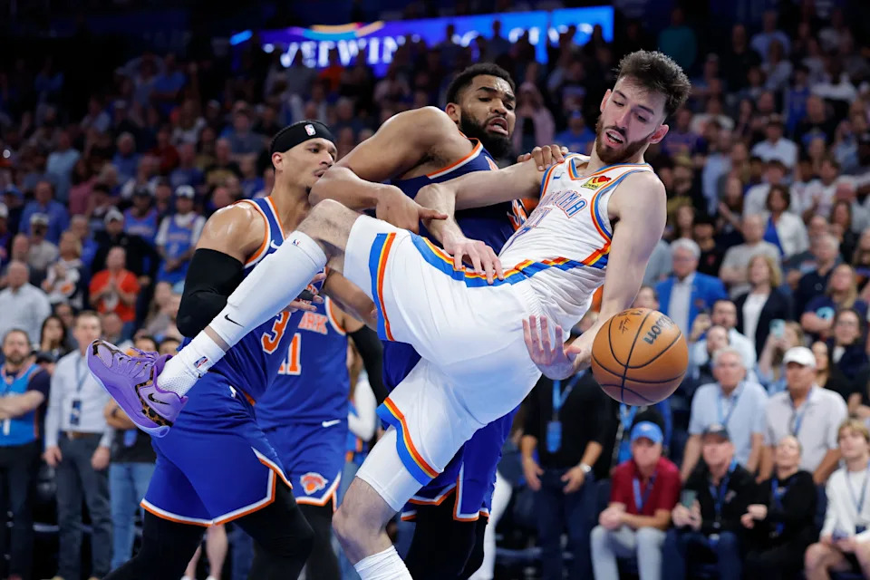Mar 29, 2026; Oklahoma City, Oklahoma, USA; New York Knicks center Karl-Anthony Towns (32) and Oklahoma City Thunder center Chet Holmgren (7) fight for a loose ball during the second half at Paycom Center. Mandatory Credit: Alonzo Adams-Imagn Images