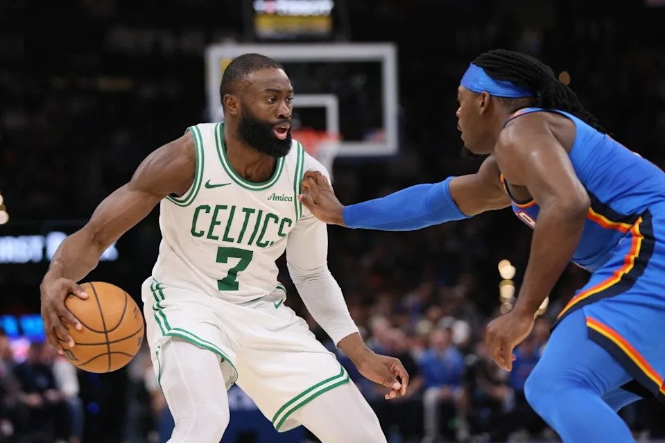 Celtics guard Jaylen Brown (7) handles the ball against Oklahoma City Thunder guard Lu Dort. AP