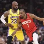 Houston Rockets forward Kevin Durant (7) dribbles the ball as Los Angeles Lakers forward LeBron James (23) defends during the first quarter at Toyota Center.