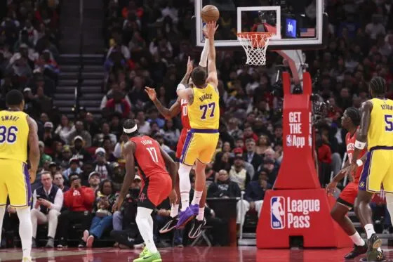 Los Angeles Lakers guard Luka Doncic (77) shoots the ball as Houston Rockets forward Jabari Smith Jr. (10) defends during the first quarter at Toyota Center.