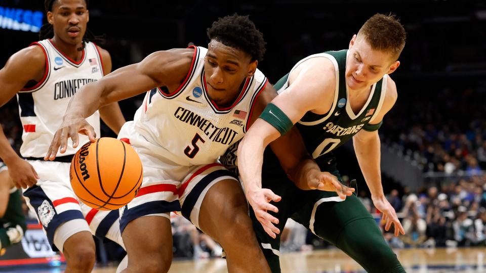 UConn Huskies forward Tarris Reed Jr. (5). And Michigan State Spartans forward Jaxon Kohler (0) attempt to get a loose ball in the first half during a Sweet Sixteen game of the East Regional of the men's 2026 NCAA Tournament at Capital One Arena. - Geoff Burke/Imagn Images/Reuters Connect