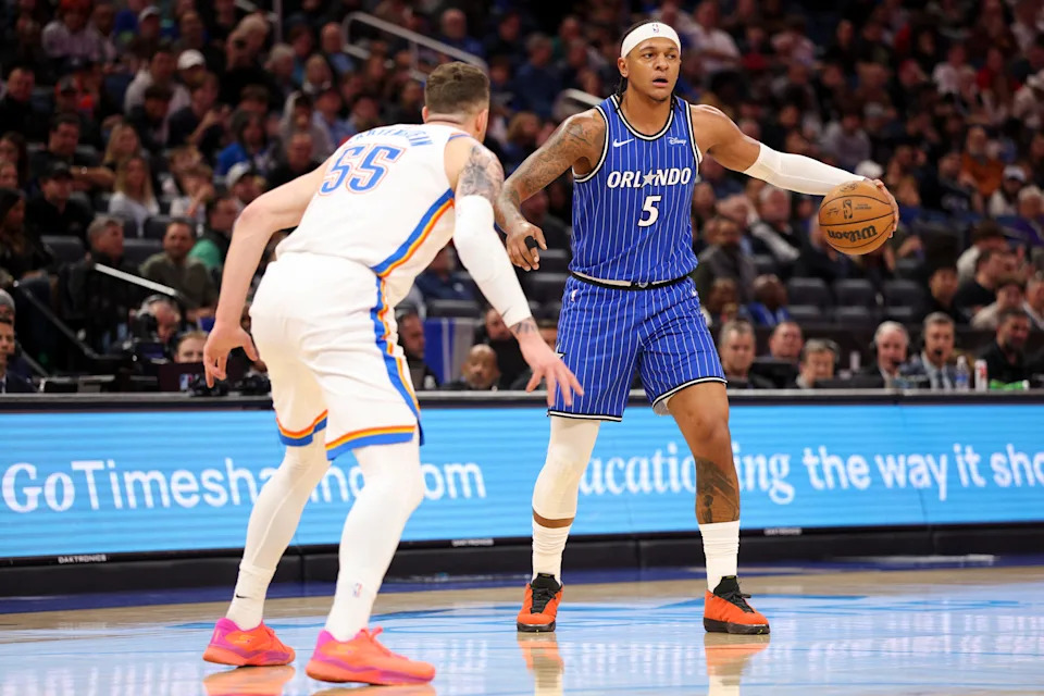 Mar 17, 2026; Orlando, Florida, USA; Orlando Magic forward Paolo Banchero (5) is guarded by Oklahoma City Thunder center Isaiah Hartenstein (55) in the first quarter at Kia Center. Mandatory Credit: Nathan Ray Seebeck-Imagn Images