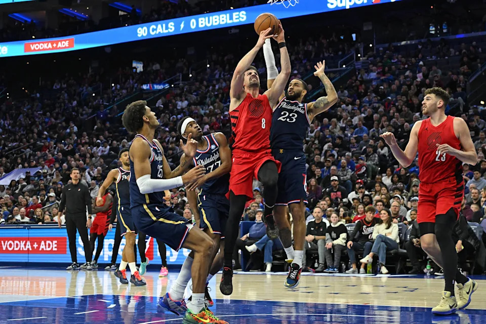 Mar 15, 2026; Philadelphia, Pennsylvania, USA; Portland Trail Blazers forward Deni Avdija (8) drives to the basket and is fouled by Philadelphia 76ers guard Tyrese Martin (23) during the first half at Xfinity Mobile Arena. Mandatory Credit: Eric Hartline-Imagn Images